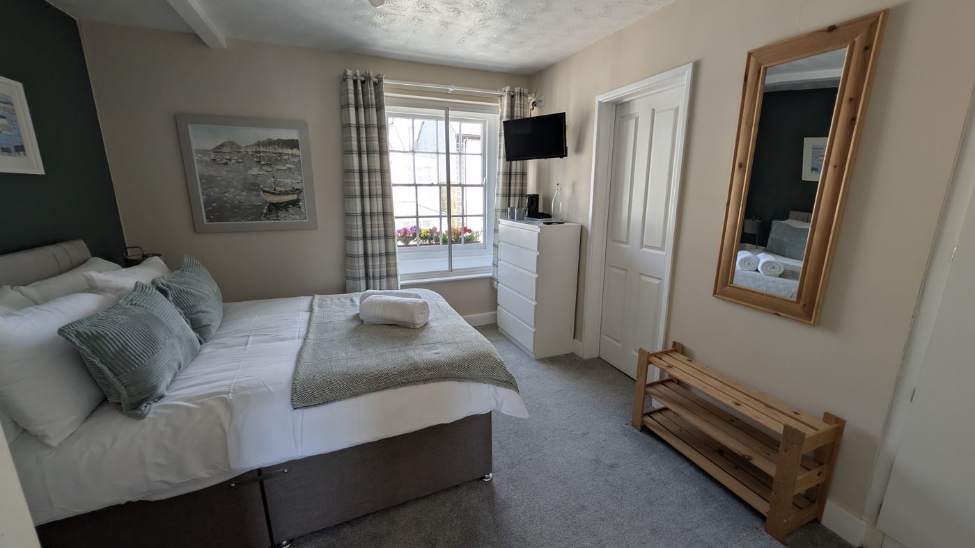 Room 3, a double room with white chest of drawers, pine mirror and luggage rack